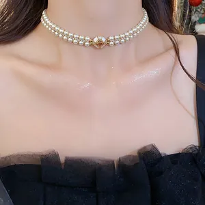 Close-up of elegant double-layer pearl choker with gold plated zircon charm on a model