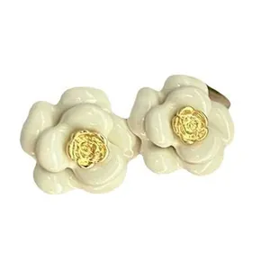 Elegant white oil-drop camellia flower stud earrings with golden centers for women.