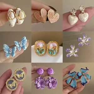 Detailed display of colorful oil-drop flower and heart-shaped stud earrings