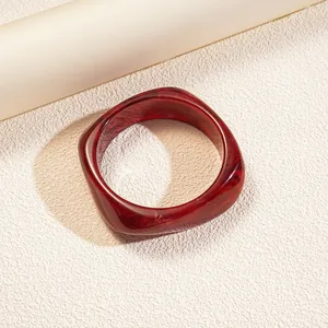 Elegant irregular red resin bangle with retro marble texture and minimalist fashion design