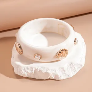 Elegant white marbled resin bangle bracelet with gold seashell and pearl embellishments