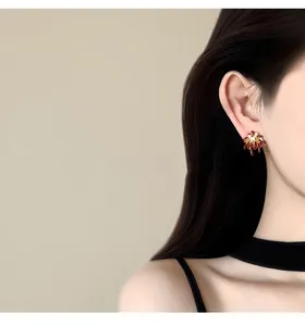 Detailed view of fashion 18k gold plated firework earrings with zircon on model ear