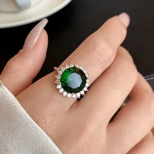 Primo piano di un elegante anello regolabile con zircone verde e sfondo in seta.