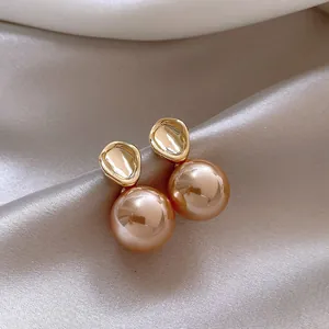 Detailed view of elegant French vintage stud earrings featuring large champagne pearls