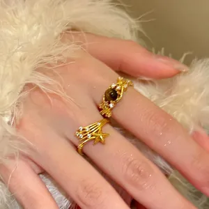 Macro view of detailed 18k gold-plated star ring with zircons and tiger eye stone