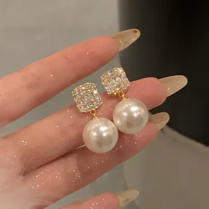Detailed view of elegant French vintage earrings with square crystals and large pearls