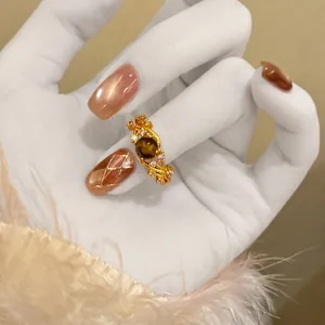 Detailed view of a vintage 18k gold plated star ring with tiger eye and zircon