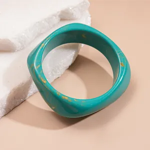 Vintage irregular thick resin bangle in teal finish with unique gold marbled pattern