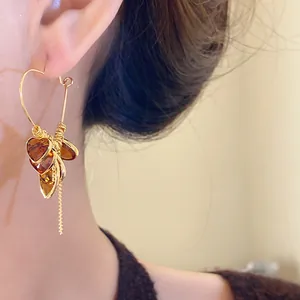 Detailed view of vintage 18K gold plated heart earrings featuring amber teardrop tassels