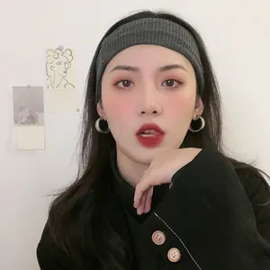 Minimalist silver needle geometric hoop earrings shown on a female model wearing a grey headband