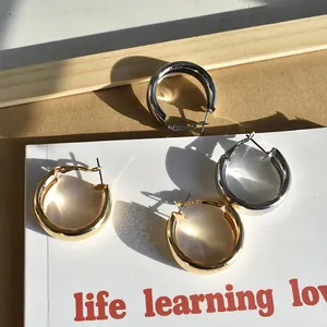Minimalist geometric hoop earrings with silver needles in gold and silver finish