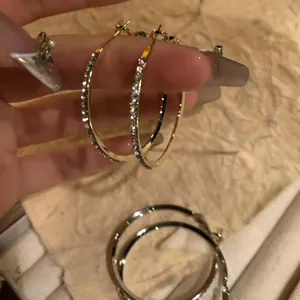 Minimalist gold and silver oval hoop earrings with sparkling crystal accents for women