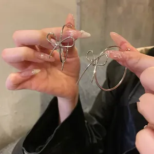 Minimalist silver bow-shaped oval hoop earrings with an elegant metallic cold-style finish