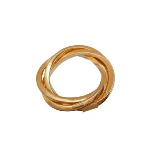 Elegant punk style gold metallic coiled irregular spiral bracelet with minimalist design