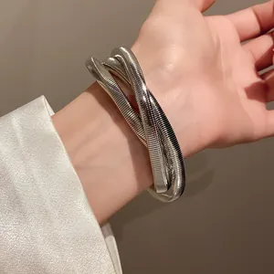 Close-up of minimalist silver metallic coiled wrap bracelet with punk style design