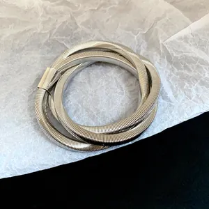 Detail of silver multi-layer snake bone bracelet with irregular spiral punk design