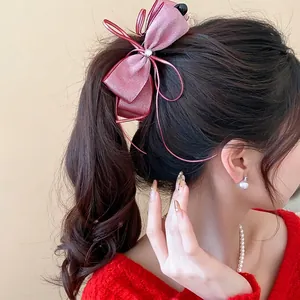 Sophisticated pink chiffon bow banana clip hair accessory perfect for high ponytail styling