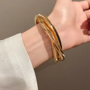 Detailed close-up showing the textured spiral pattern of a chunky gold punk bracelet