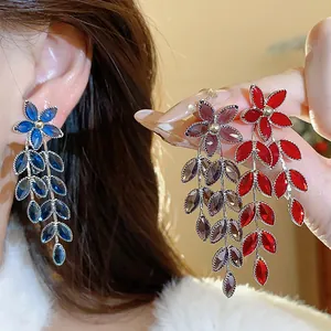 Detailed view of floral and leaf tassel earrings featuring vibrant glass crystals in multiple colors