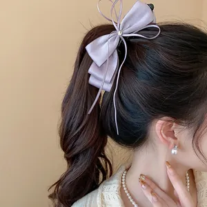 Elegant purple chiffon bow banana clip shown in a stylish ponytail hairstyle.