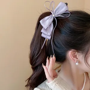 Elegant lavender chiffon ribbon bow banana hair clip styled on a dark brown ponytail.