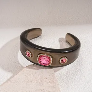 Vintage resin cuff bracelet featuring three pink gemstones with crystal halo settings.