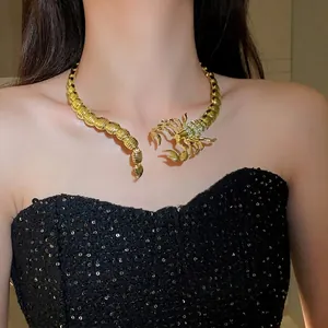 Gold-tone scorpion choker necklace with crystal pave accents worn by a fashion model
