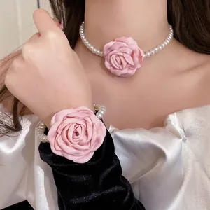 Elegant pink fabric flower and pearl jewelry set including choker and bracelet for women