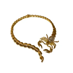 Bold statement gold scorpion choker necklace with sparkling rhinestones for edgy style.