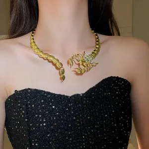 Detailed close-up of a golden scorpion choker necklace with sparkling rhinestones.