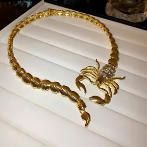 Detailed view of a gold-tone scorpion choker necklace with sparkling rhinestones
