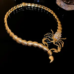 Detailed macro view of the gold-toned chunky scorpion choker necklace with rhinestones.