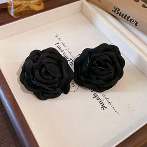 Close-up detail of vintage French style black fabric rose flower accessories