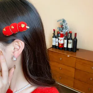 Festive red flocked duckbill hair clip with gold accents for New Year celebration