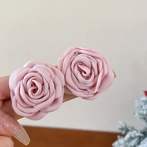 Close-up detail showing two delicate pink fabric roses on a sweet style necklace detail