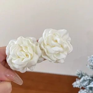 Close-up of elegant cream fabric rose flower accessories with delicate petals