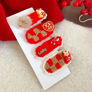 Detailed view of festive red flocked hair clips with lion mascot and lucky charms