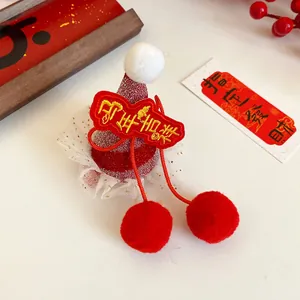 Detailed close-up of festive red Chinese New Year Snake themed hair clip with pom-poms