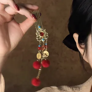 Exquisite traditional Chinese New Year hair comb with red tassels and golden lion detail