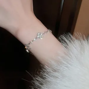 Elegant silver-tone four-petal flower zircon bracelet with an adjustable chain for women