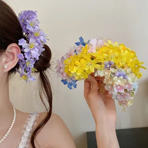 Detail view of multi-colored fabric flower hair fork pins for elegant styling
