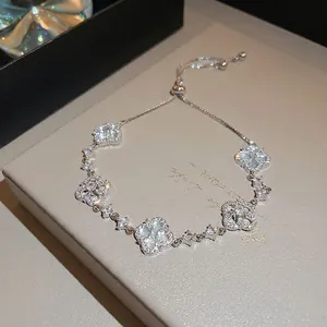 Elegant adjustable silver bracelet with sparkling zircon four-leaf flower charms