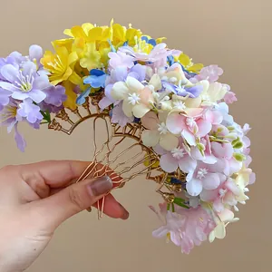 Detailed view of handmade Mori style fabric flower hair fork with golden wavy metal pins