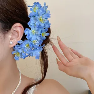Detailed view of elegant blue fabric flower hairpin for forest style hairstyle