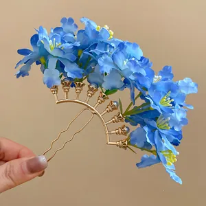 Detailed view of elegant blue fabric flower hair fork with a stylish gold metal base