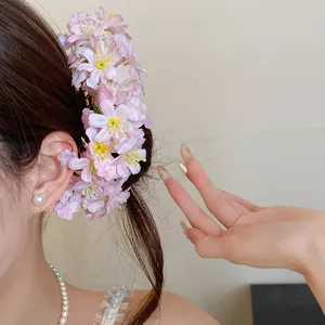 Detail shot of a sweet fabric flower hairpin with delicate pink blossoms in hair