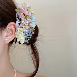 Detailed view of a forest-style fabric floral hairpin with pastel hydrangea petals.