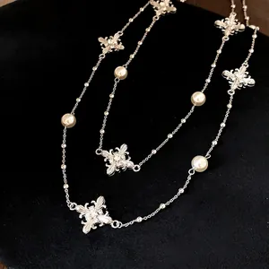 High-end elegant pearl beaded necklace with sparkling crystal cross charms on black velvet