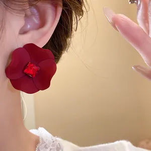 Elegant close-up view of a deep red flower earring featuring a square ruby-like rhinestone