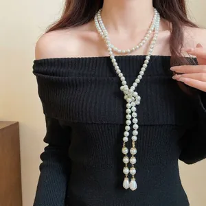 Vintage multi-layer long pearl necklace with elegant knot design and pearl tassel accents